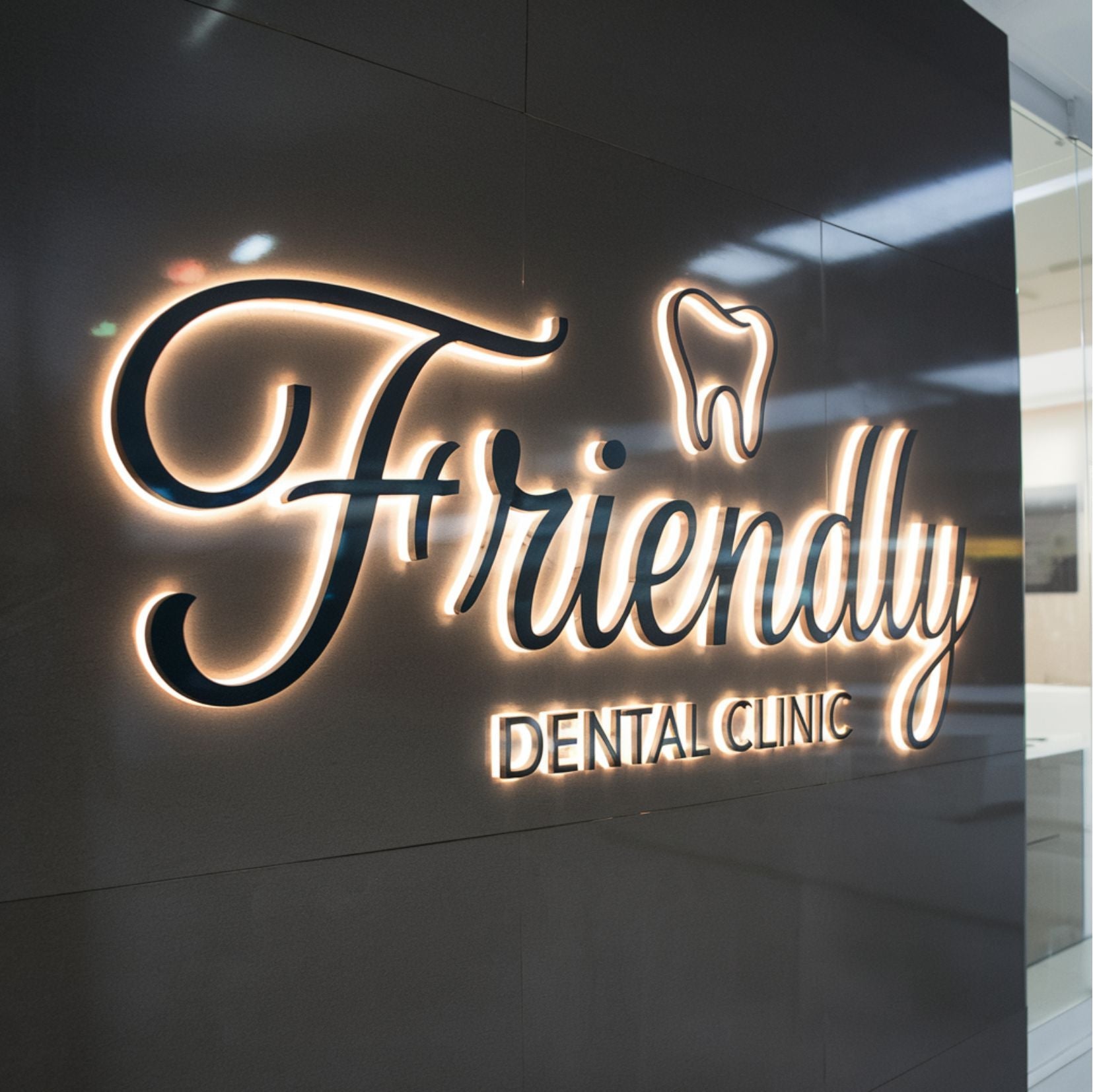 Front view of Friendly Dental Clinic 3D backlit metal sign